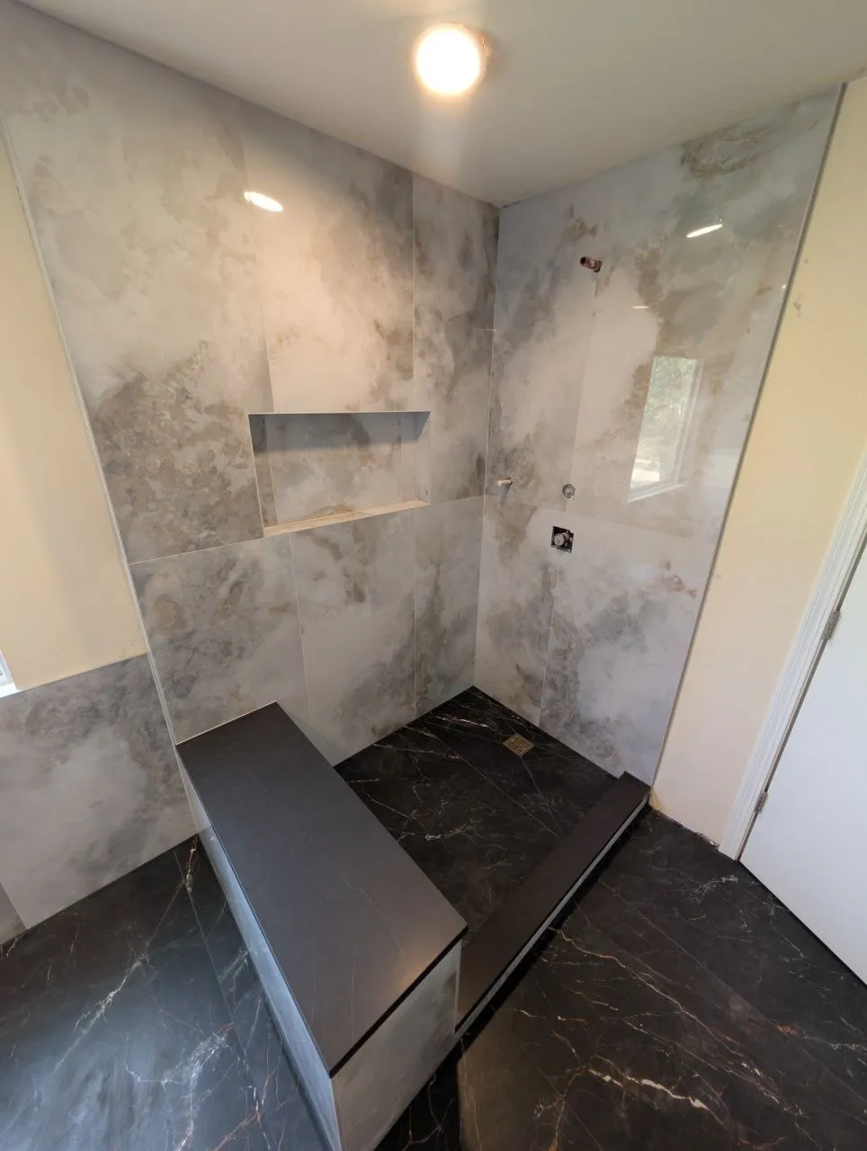 Wide view of renovated shower with large-format porcelain walls, Naperville IL