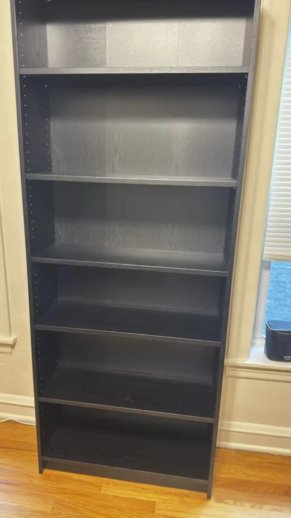 Tall black bookcase with adjustable shelves assembled in Evanston, IL.