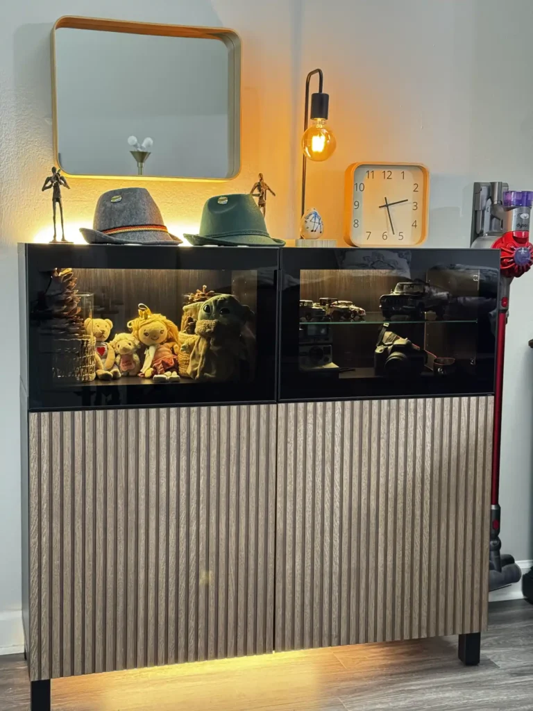 IKEA BESTÅ display cabinet with glass doors, textured fronts and under-cabinet lighting