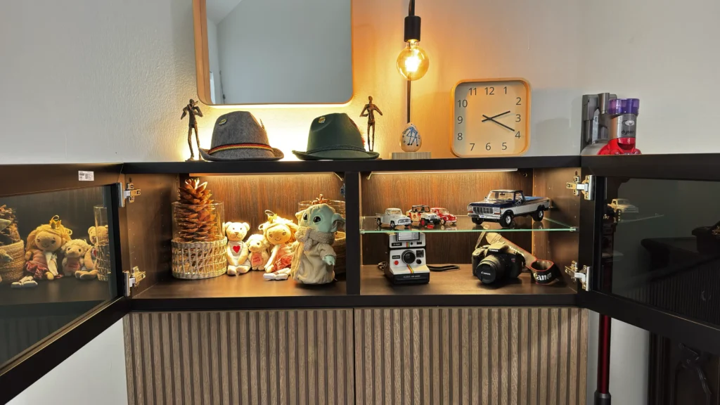 IKEA BESTÅ display cabinet with open glass doors, illuminated shelves and textured fronts