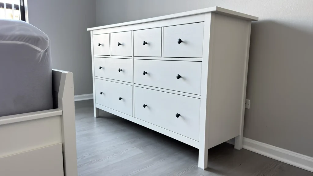 White IKEA HEMNES eight-drawer dresser installed beside a bed in Palatine, IL