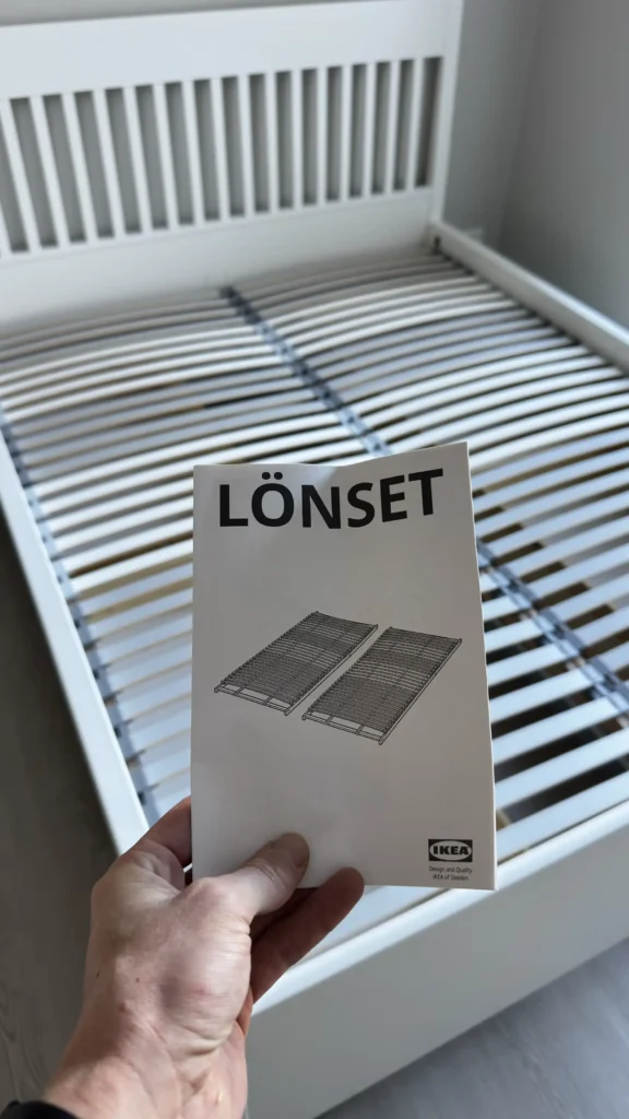 IKEA LÖNSET slatted bed base installed inside a white IDANÄS bed frame