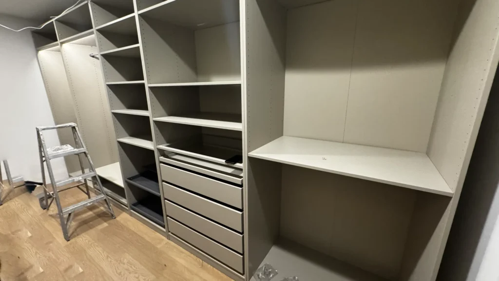 IKEA PAX closet with open shelves, pull-out drawers and wardrobe sections in Lake Forest, IL.