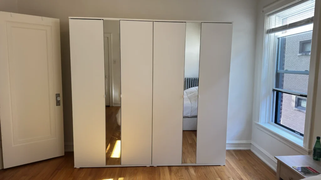 Two white mirrored wardrobes assembled in a bedroom in Evanston, IL.