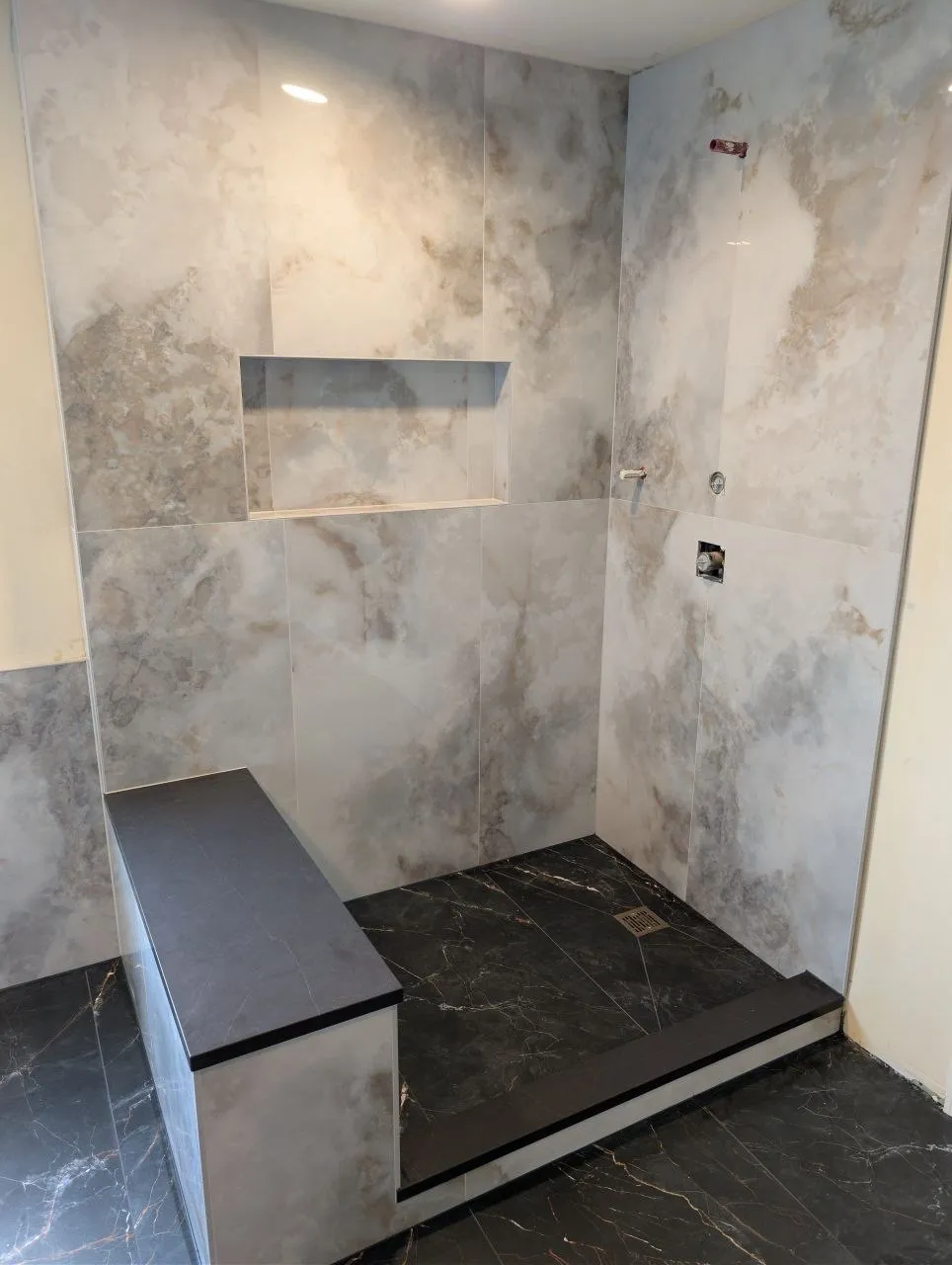 Large-format porcelain shower walls with recessed niche and tiled bench, Naperville IL