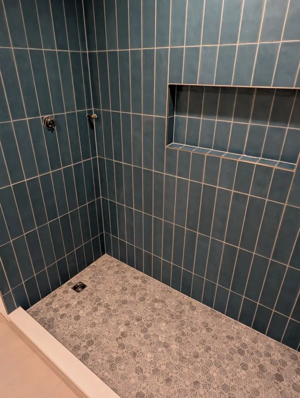 Patterned hexagon mosaic shower floor with linear drain and white curb, Highland Park IL