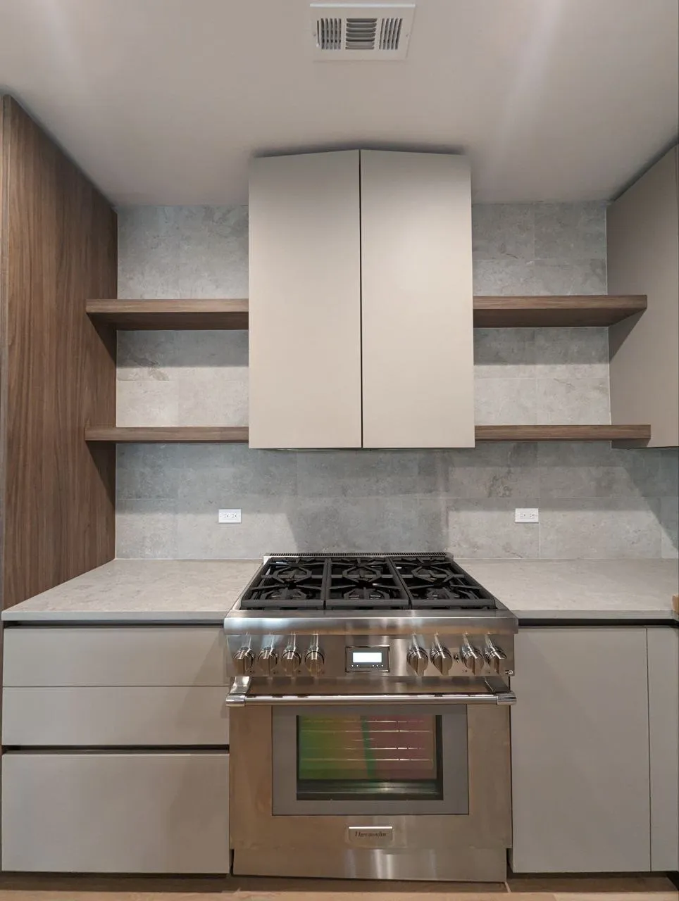 Porcelain 12x24 tile kitchen backsplash in horizontal stack bond behind range, Downtown Chicago IL