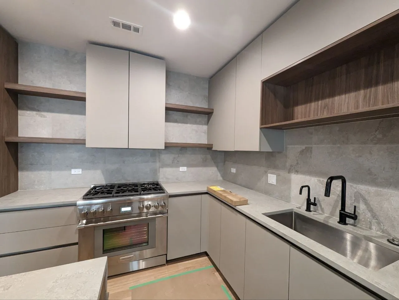 Kitchen with porcelain tile backsplash installed to countertop with silicone caulk joint, Downtown Chicago IL
